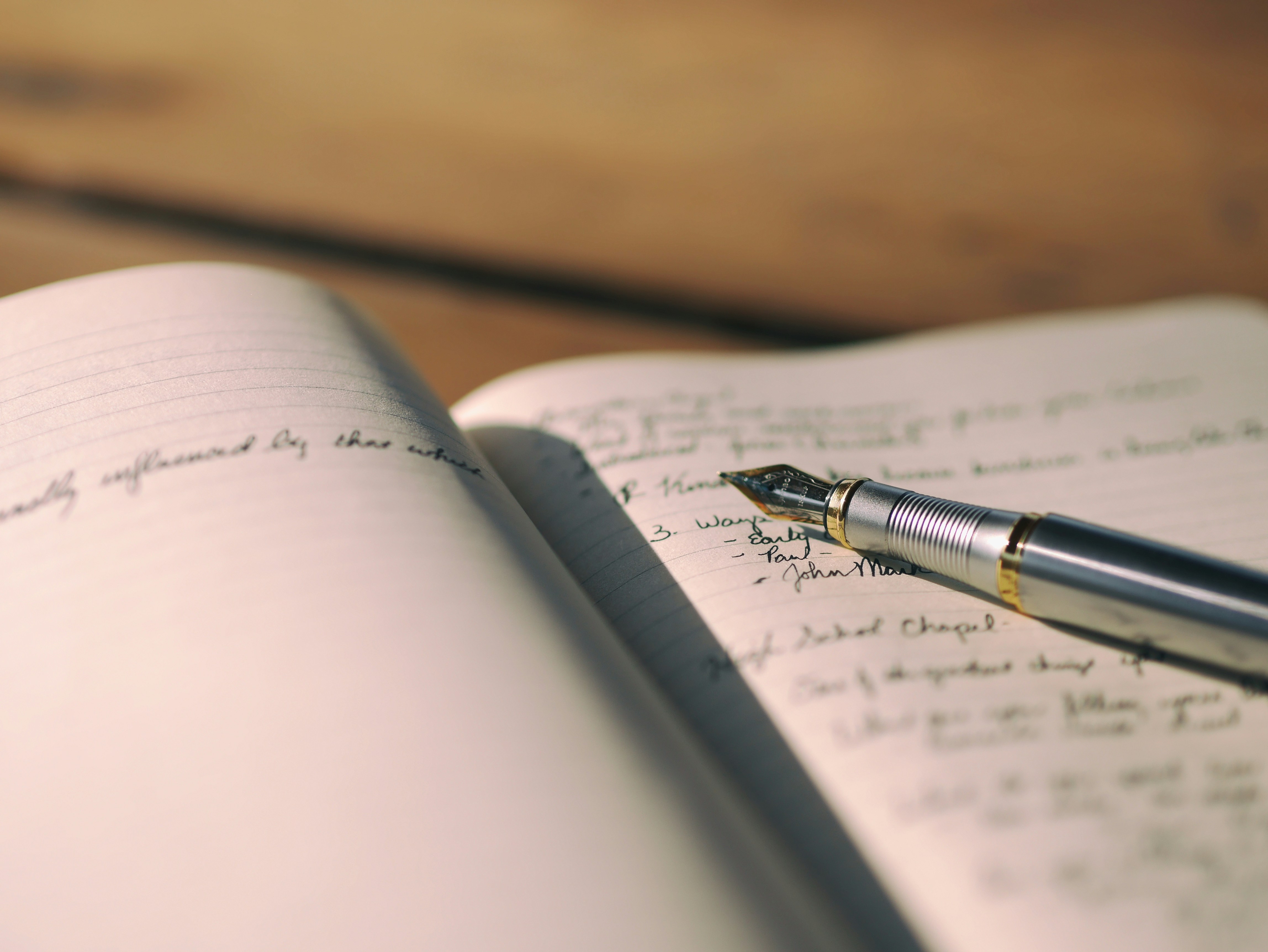 A book with Pen resting on it