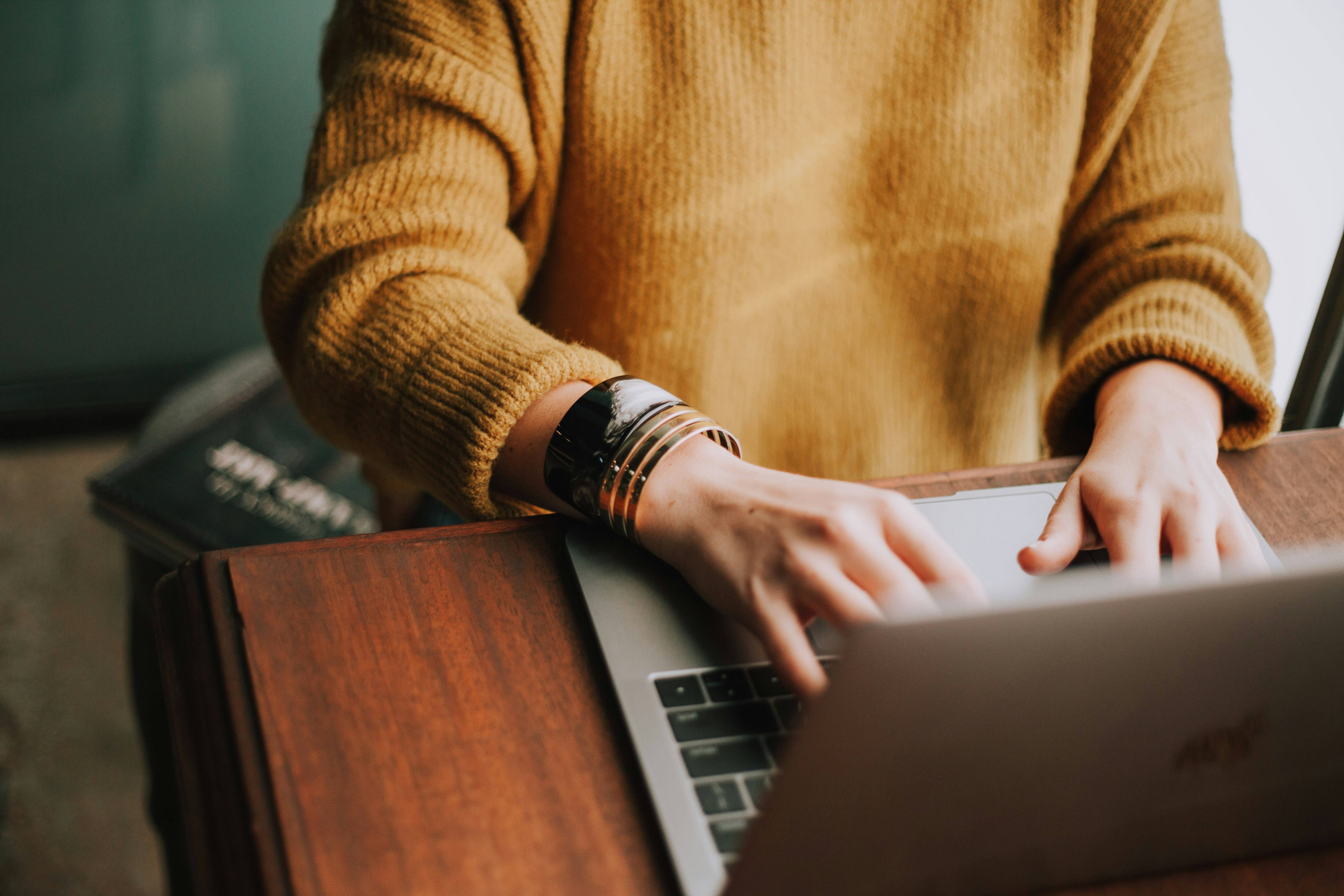 A female typing on a laptop