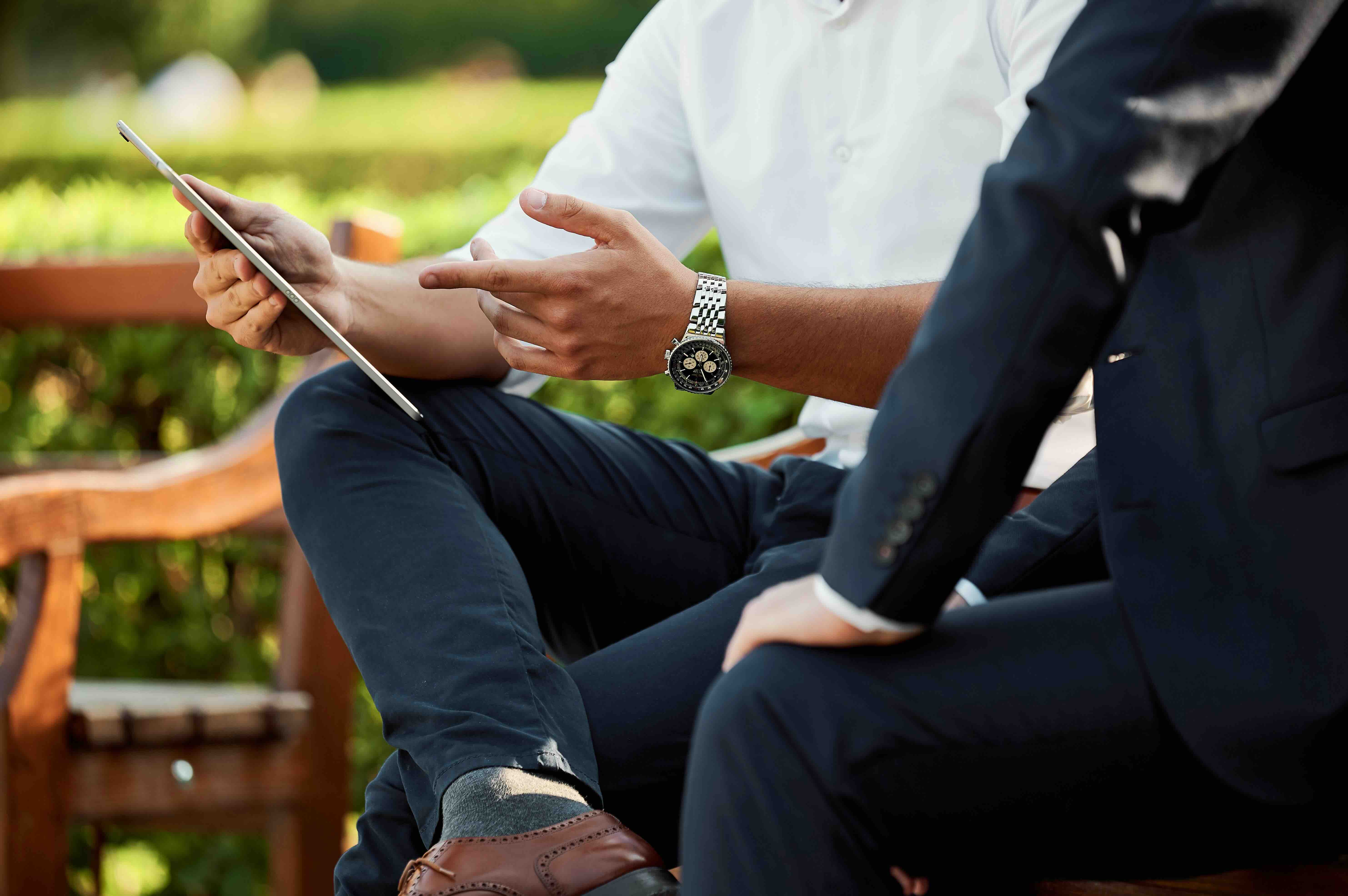 A person sitting on bench with iPad