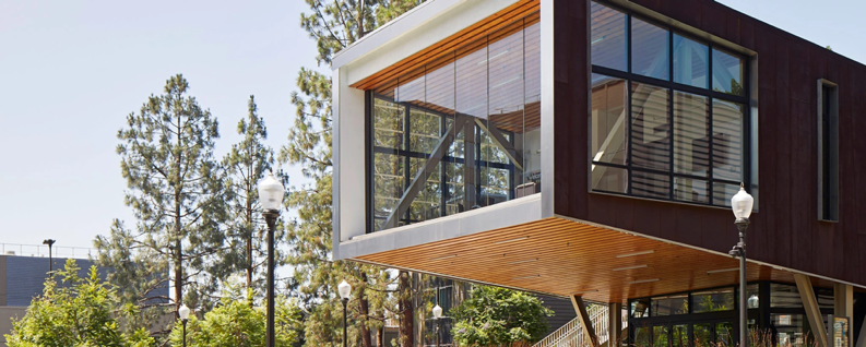 A building with a glass wall and a person walking